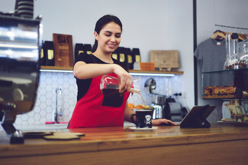 Confident smiling coffee maker enjoying working process