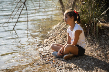 A girl thinking in the lake