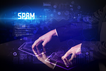 Hand touching digital table with SPAM inscription, new age security concept