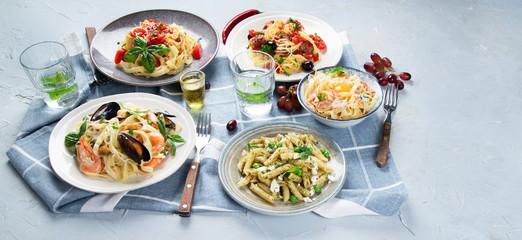 Plates of pastas with different kinds of sauces.