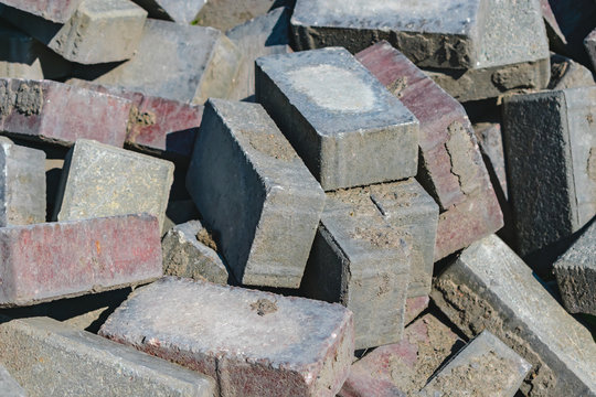 Disassembled building bricks stacked in a large pile close up