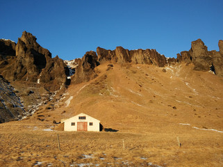 A lonely house at the foot of the mountains in Iceland. Incredible landscapes of nature. Life for a...