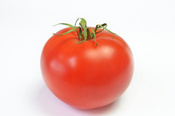 Ripe red tomato on a bright white background