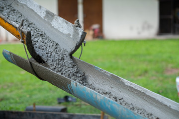 Workers are pouring, concrete and equipment
