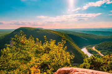 Mountain Range with River flowing in between and Blue Sky in background