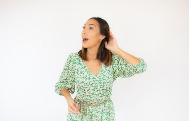 Beautiful woman in green dress with listening gesture