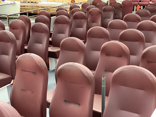 Naklejka premium Soft seats are arranged in rows. Soft seats on a tourist boat. Soft armchairs in brown. Upholstered leather armchairs.