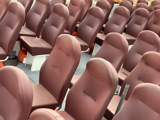 Fototapeta premium Soft seats are arranged in rows. Soft seats on a tourist boat. Soft armchairs in brown. Upholstered leather armchairs.