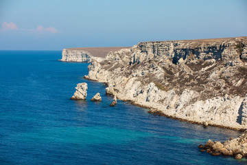 Summer beach day. Landscape of sea coast with beautiful rocks.