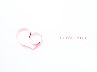The heart is made of red paper on a white background. I love you in English. Valentine's Day.