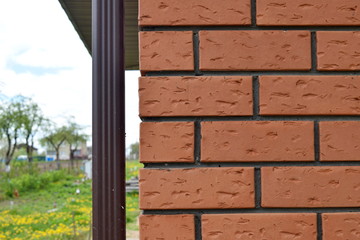 Corner of the house made of red bricks