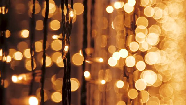 Decorative string lights hang and glow, vintage garland of lamps, warm lighting