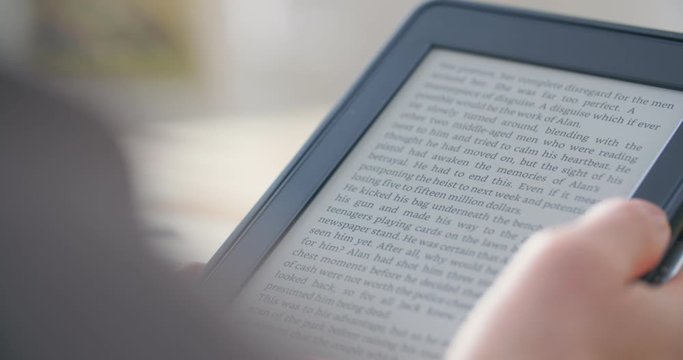 Woman reading an ebook on a reader with an e-ink display.
