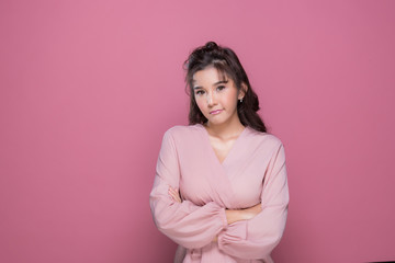 Fototapeta premium Portrait beautiful young woman in the studio on pink background 