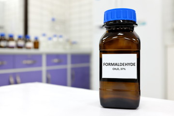 Selective focus of formaldehyde or formalin in brown amber glass bottle inside a laboratory....
