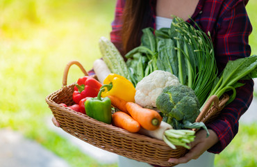 Beautiful woman carrying vegetables with blur background 
