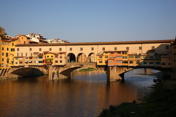 Fototapeta na wymiar View of Ponte Vecchio bridge during the sunrise in Florence, Tuscany, Italy