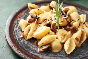 Plate with tasty conchiglie pasta, closeup