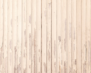 Fototapeta na wymiar old beige grungy paint blisters on vertical wooden planks
