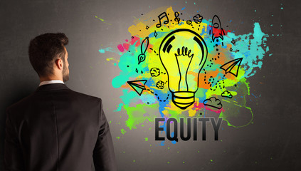 businessman drawing colorful light bulb with EQUITY inscription on textured concrete wall, new business idea concept