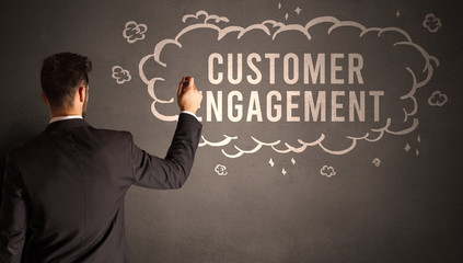businessman drawing a cloud with CUSTOMER ENGAGEMENT inscription inside, modern business concept