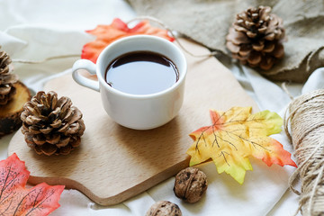 Autumn fall leaves, hot steaming cup of coffee on white background. relaxing and still life concept.