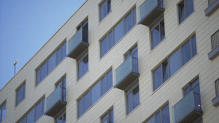 Close up shot of residential building. Close up Of An Apartment Blocks. The building features exterior with small balconies