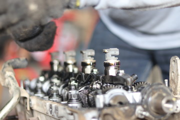 The mechanic is checking the engine.
