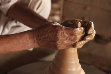 Potter man, clay molding, shaping clay molding potter, potter hand clay mold