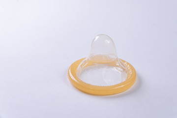 Latex condom on white background