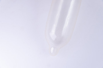 Latex condom on white background