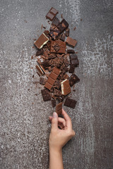 Pile of chopped, milled dark and milky chocolate slices and shavings top view.