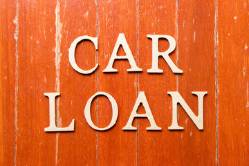 Alphabet letter in word car loan on old red color wood plate background