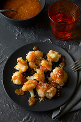 Buffalo barbecue cauliflower on dark background. Top view. Summer food concept