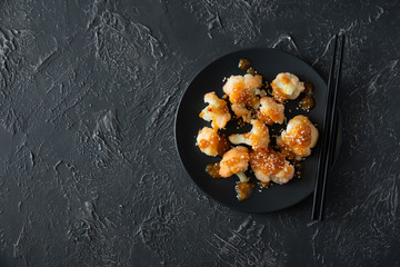 Buffalo barbecue cauliflower on dark background. Top view. Summer food concept