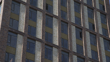 Generic day time establishing exterior brick apartment loft building in one of the districts urban city.