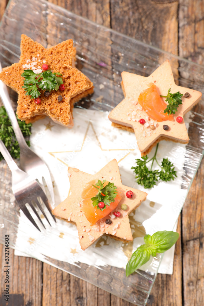 Wall mural gingerbread toast with foie gras and smoked salmon- christmas or new year celebration canape