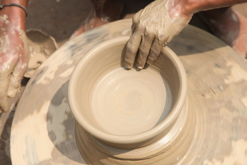 potter at work, clay making pot