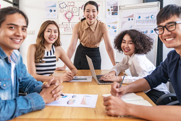 Portrait of young attractive asian team smile and look at camera in financial performance or organization productivity meeting, career or job concept with feeling happy and cheerful in casual outfit.
