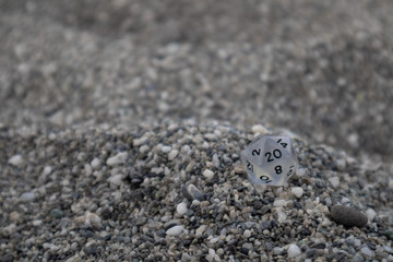 Clear Dungeon and Dragons dice with character sheets at the beach