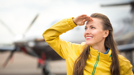 Young woman in front of the airplane