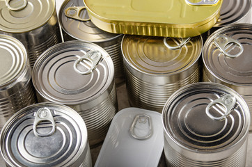 Set of various canned foods in tin cans on kitchen table, non-perishable, long shelf life food for...