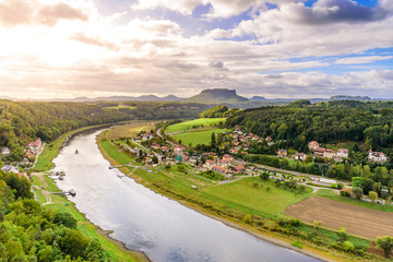 View from the bastei viewpoint of the Elbe river and the Rathen town in beautiful landscape scenery, Sandstone mountains, Saxon Switzerland National Park, Germany