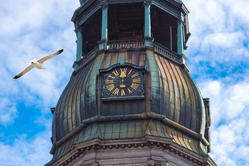 Close-up of spire with clock of St. Peter’s Church, old town in Riga, Latvia