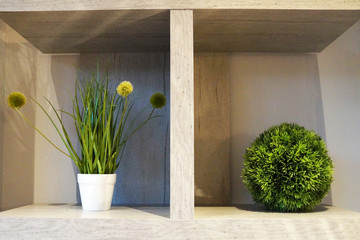 white interior shelf with decorative balls and potted plants