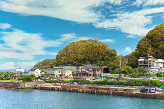 Coast of the Kanaya village in Futtsu city along the Uraga Channel with the National Route 127 passing through a tunnel in the cliffs of the Mount Nokogiri stone quarry.