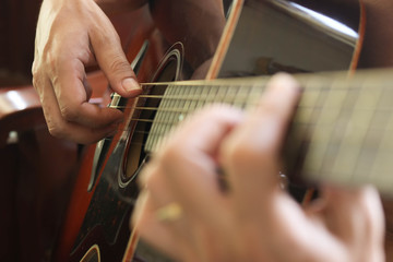Fototapeta na wymiar close up of man's hand playing guitar