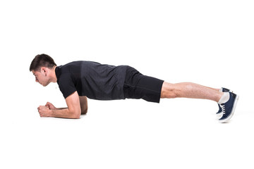 Young man on abdominals workout Basic Plank posture on white background