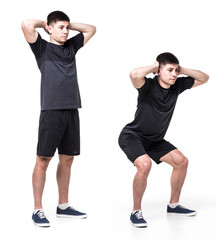 Athletic young handsome man doing squats, isolated on white.