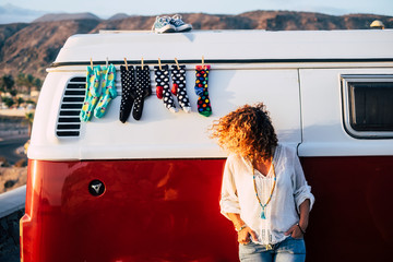 Trendy fashion young woman people outside a cozy and beautiful vintage retro van with socks and...
